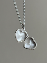 Hands wrapped around a heart Design Locket Pendant top